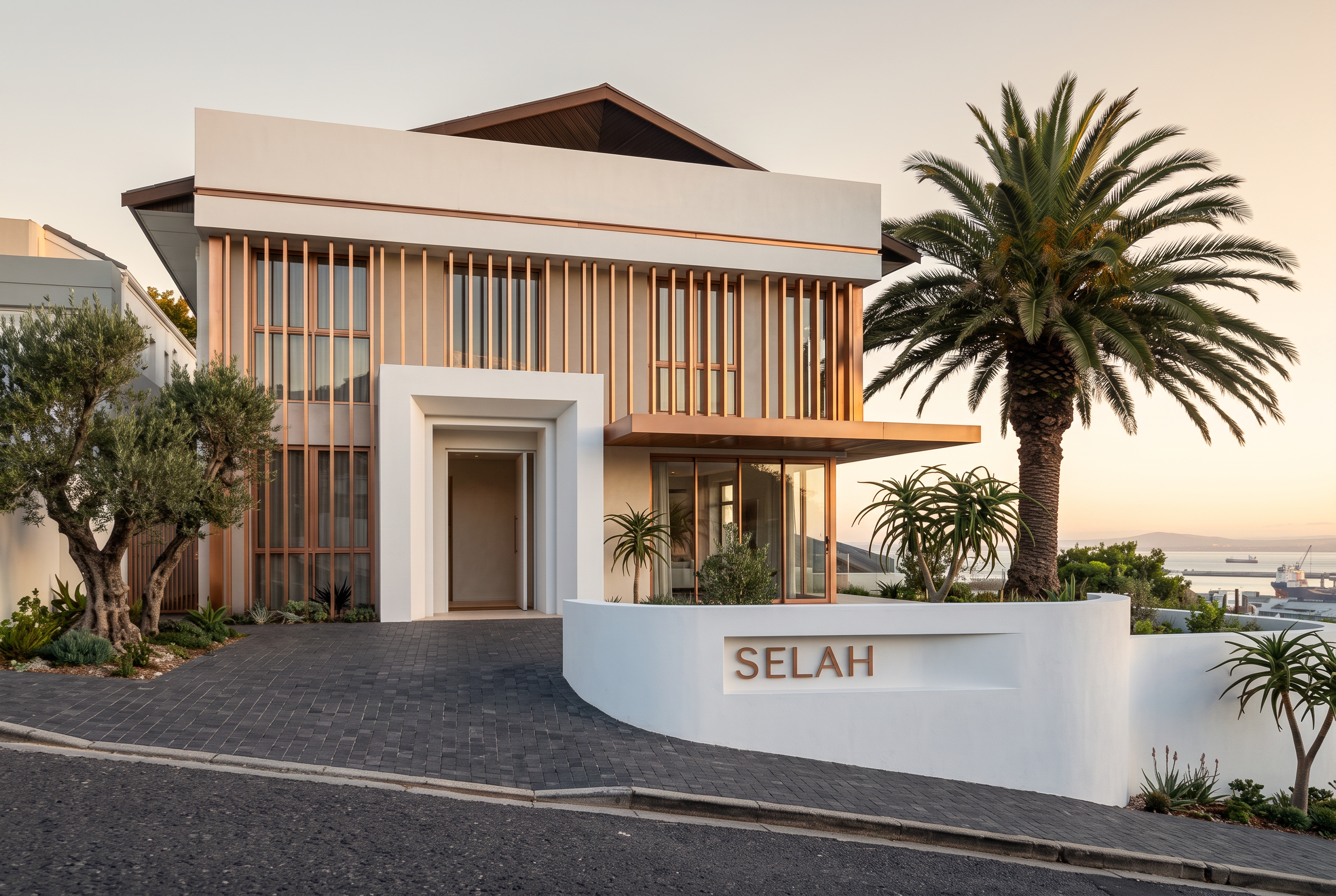 The Selah — chalk-white plaster and gold facade on Ella Street, Bo-Kaap, at dusk